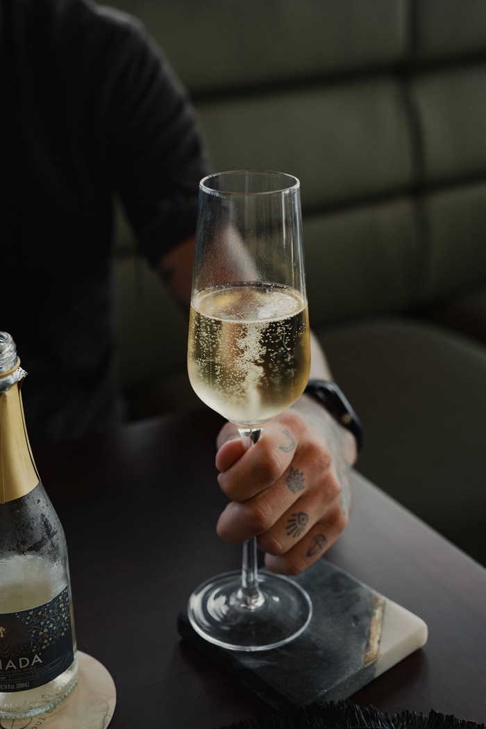 A chilled zero-proof sparkling flute at the bar