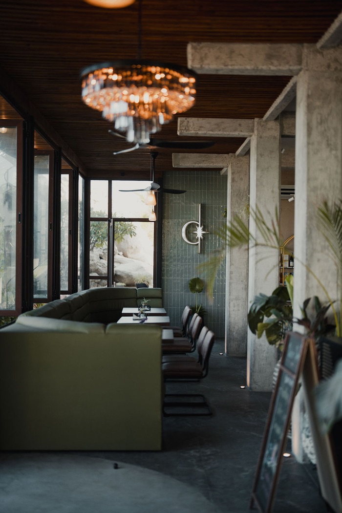 The green lounge beneath the crystal chandelier, the SEAD moon and star on the wall