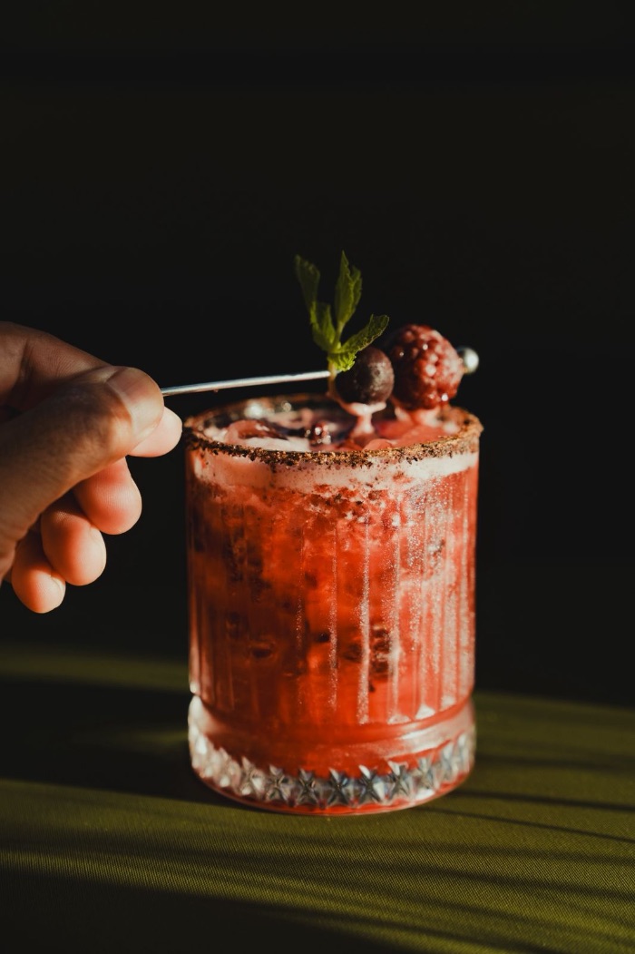 La Sirena — the berry elixir from the video, over cracked ice with frozen berries and mint