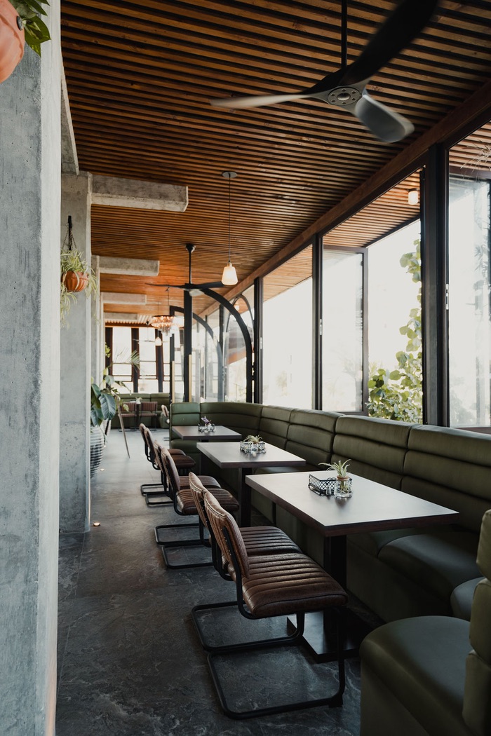 Olive banquettes along the glass